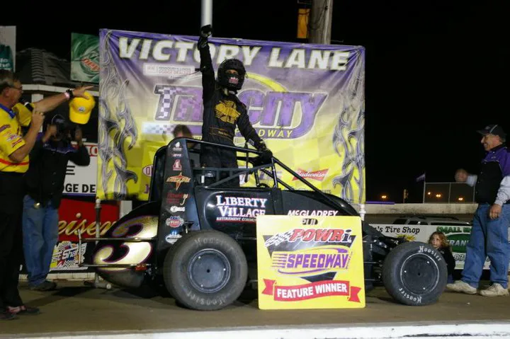 Darren standing on his midget in Tri-City Speedway victory lane